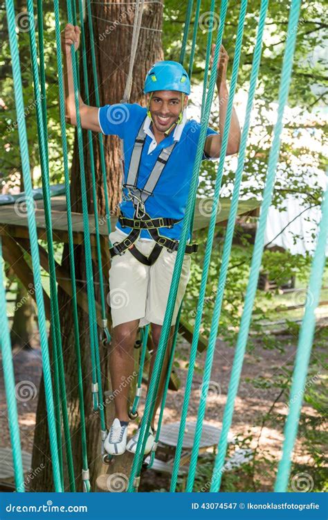 Man Climbs Over Obstacles At High Rope Court Stock Image Image Of