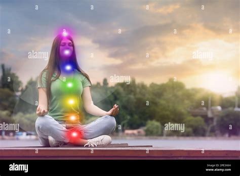 Teenage Girl Meditating Near River Scheme Of Seven Chakras