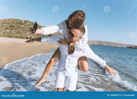 Young Happy Couple Taking Selfie On The Beach Summer Vacations Concept