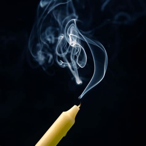 Premium Photo Smoke From An Extinguished Candle On A Dark Background