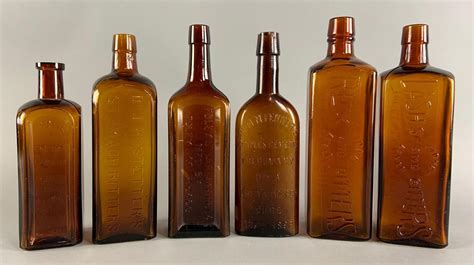 Group Of 6 Antique Amber Bottles W Embossed Lettering