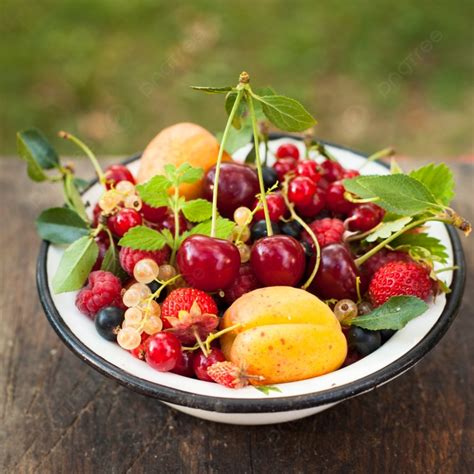 Summer Fruits In Enamelled Metal Bowl On Wooden Table Photo Background