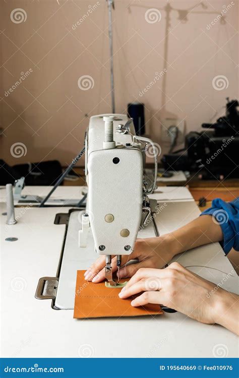 Side View Of Professional Sewing Machine In The Workshop Woman`s Hands