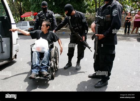 Salvadorian Police Officers Present A Handicapped Member Of The Mara