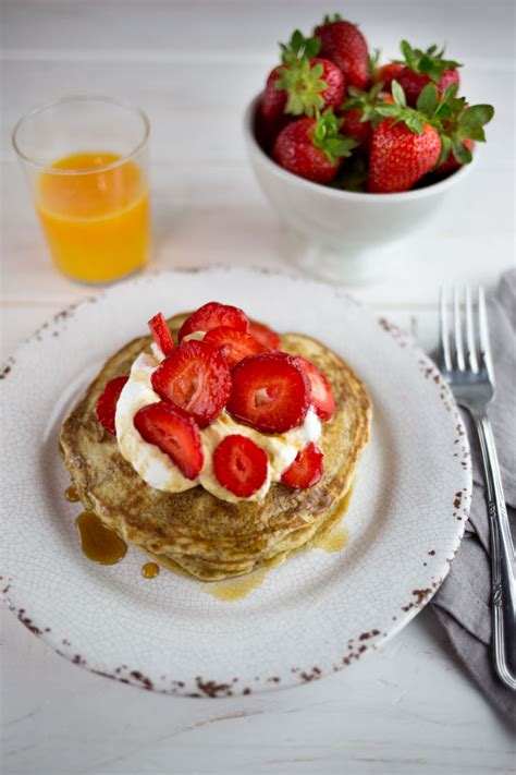 Farro Pancakes With Whipped Cream Strawberries And Maple Syrup