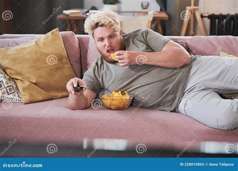 Lazy Man Eating Potato Chips And Watching Tv Stock Image Image Of