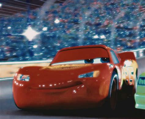 the cars from disney pixars are driving down the track in front of an ...