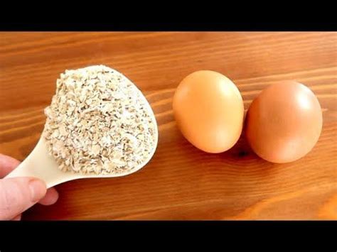 An Egg And Two Eggs Are On A Wooden Table Next To A Person S Hand