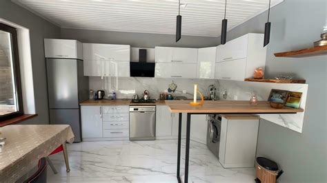 interior of new modern kitchen with white marble and beige walls ...