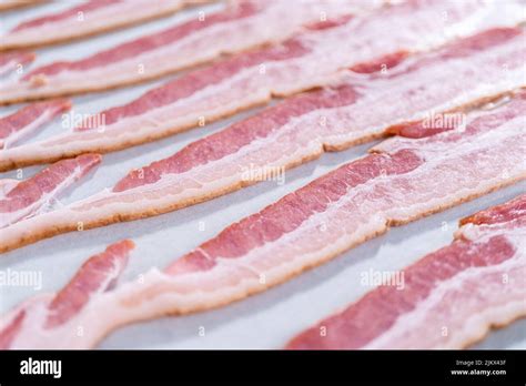 Cooking bacon strips Stock Photo - Alamy