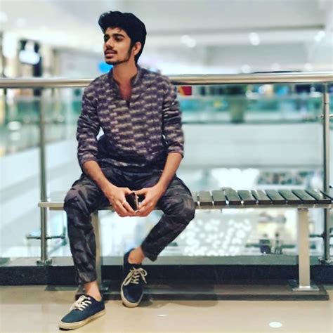 premium photo full length  young man sitting  bench  mall