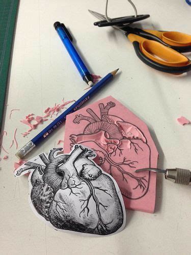 A Heart Shaped Paper Cut Out Next To Scissors And Crayons