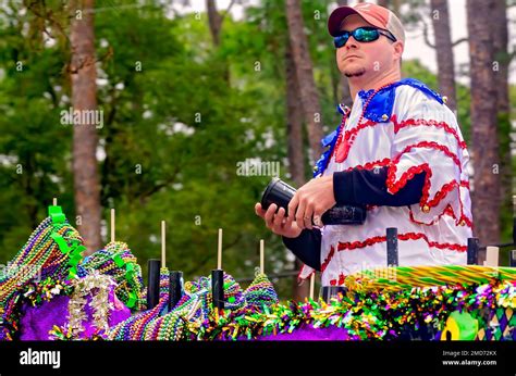 Members Of Krewe De La Dauphine Ride A Mardi Gras Float During The