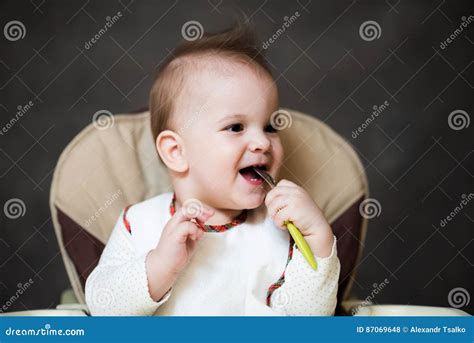 Baby Holding A Spoon In His Mouth Stock Photo Image Of Expression