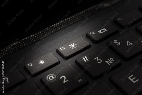 laptop computer keyboard with backlight icon on the key, the concept of ...