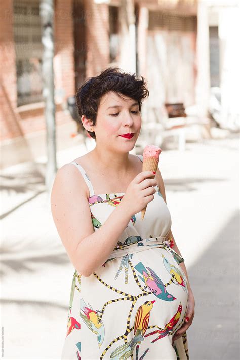 Pregnant Woman Eating A Ice Cream By Stocksy Contributor Vera Lair