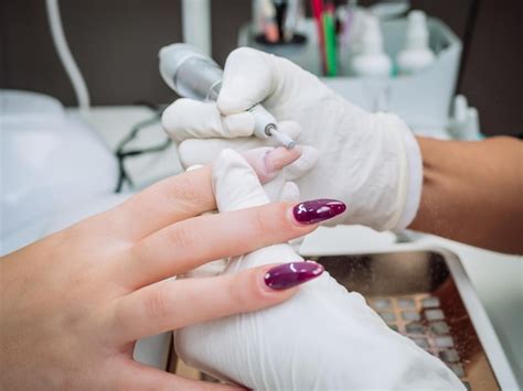 Free Photo Professional Esthetician Using An Electric Nail File Drill