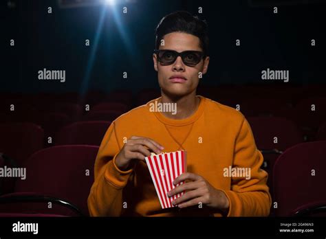 Man Having Popcorn While Watching Movie Stock Photo Alamy