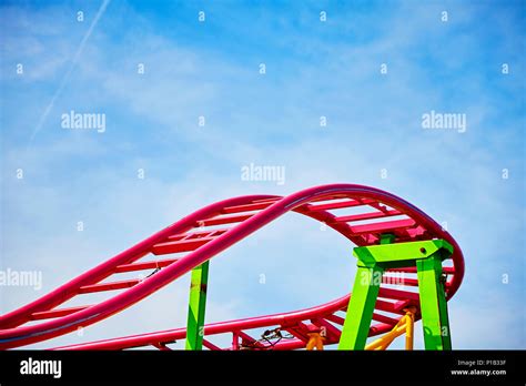 Roller coaster pink tracks in an amusement park, ups and downs concept ...