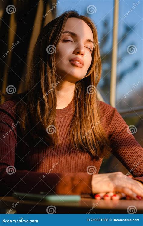 Portrait Of A Beautiful Young Girl Illuminated By Sunset Warm Light