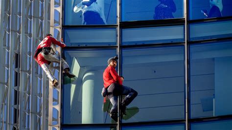 'French Spiderman' climbs first skyscraper with son in Barcelona | CTV News