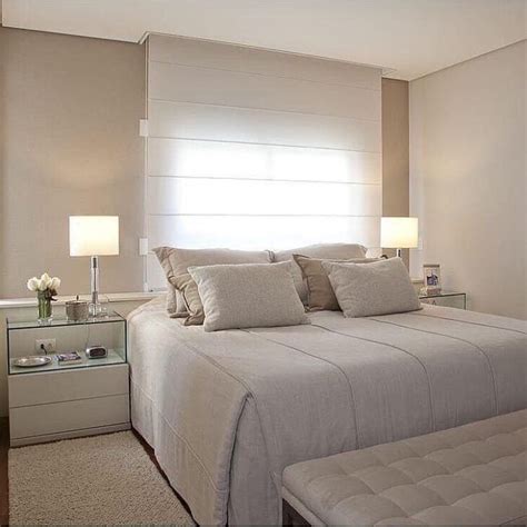 A Bedroom With A Large Bed And White Walls