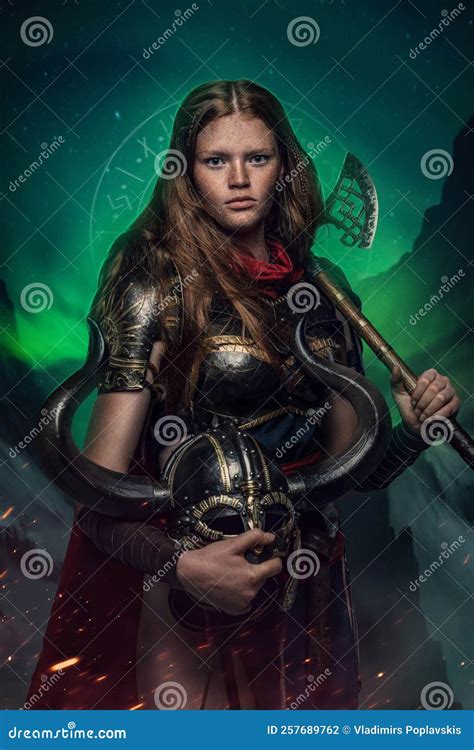 Female Warrior With Helmet And Axe Dressed In Armor Against Polar