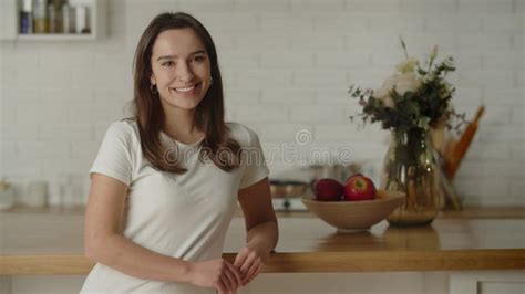 Portrait Shot Of A Long Haired Brunette With A Snow White Gait View Of A Smiling Brunette