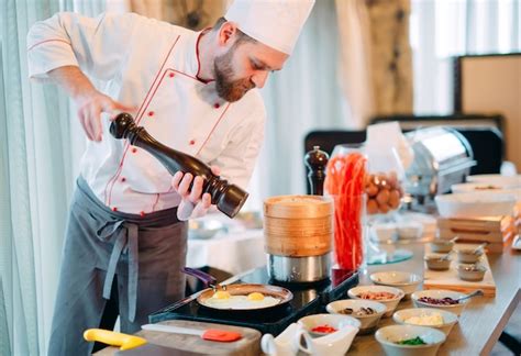 Premium Photo Breakfast The Chef Prepares Eggs For Breakfast