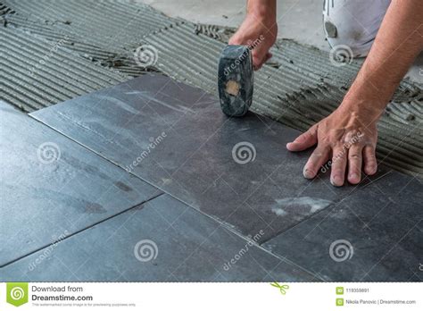 Worker Placing Ceramic Floor Tiles On Adhesive Surface Stock Image