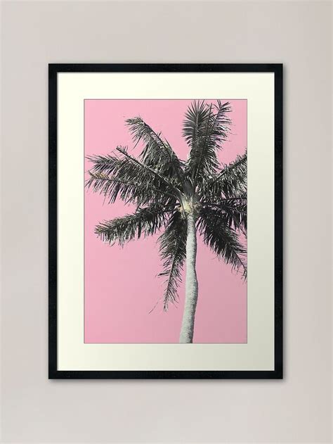 A Palm Tree Against A Pink Background Framed Art Print By Artist And