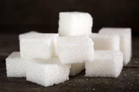 One Sugar Cube In Heart Shape And Wooden Spoon Filled With Sugar Stock