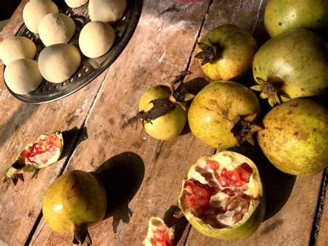 Premium Photo High Angle View Of Pomegranates On Table