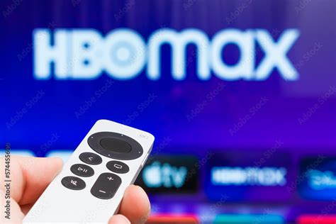 HBO Max on Apple TV showing on the screen of TV. Man hands switch on ...