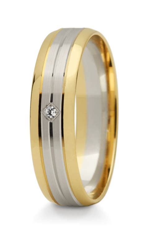 Two Tone Gold And White Ceramic Wedding Ring With A Diamond In The