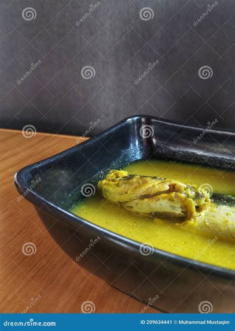 Delicious Ikan Patin Tempoyak in a Black Bowl on a Wooden Table with ...