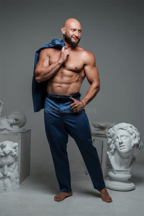 Bearded Muscular Guy With Naked Torso Around Marble Busts Stock Image