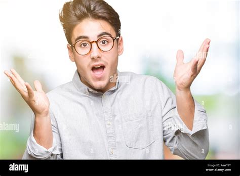 Young Handsome Man Wearing Glasses Over Isolated Background Celebrating