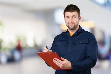 Premium Photo Delivery Man With Clipboard On Light Background