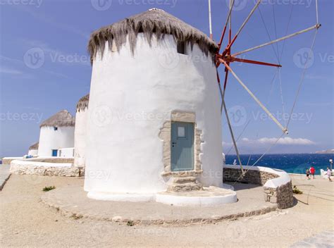 Traditional Greek windmills on Mykonos island under cloudy sky. Aerial
