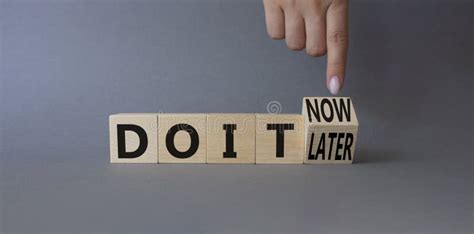 Do It Now Or Later Symbol Businessman Hand Points At Wooden Cubes With