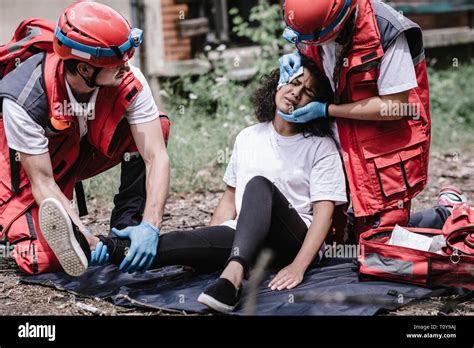 Disaster Relief Rescue Team Helping Injured Woman Stock Photo Alamy