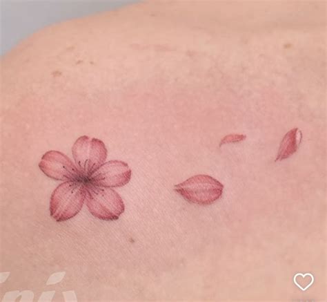 A Woman S Back With Pink Flowers On It