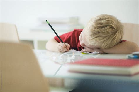 Boy Doing Homework By Stocksy Contributor Stephen Morris Stocksy