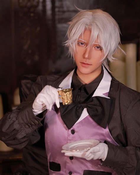 A Man With White Hair Wearing A Black And Purple Outfit Holding A Gold