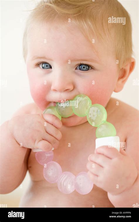 Baby Biting On Teething Ring Stock Photo Alamy