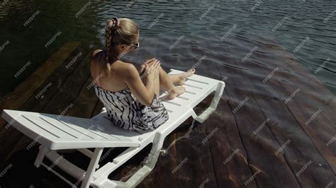 Premium Photo Woman Lie On A Sunbed In Sunglasses And A Boho Silk