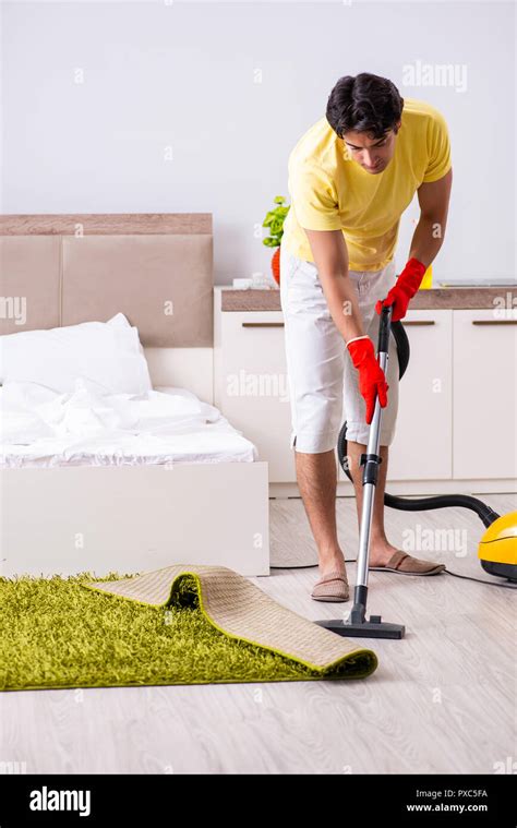 Young Handsome Man Cleaning In The Bedroom Stock Photo Alamy