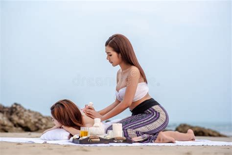 Beautiful Asian Woman Enjoying Spa Massage Therapy On The Beach Stock