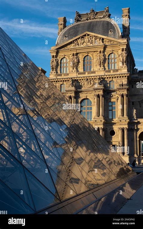 Paris, France - 02 21 2023: Reflection of facade of the Louvre museum ...